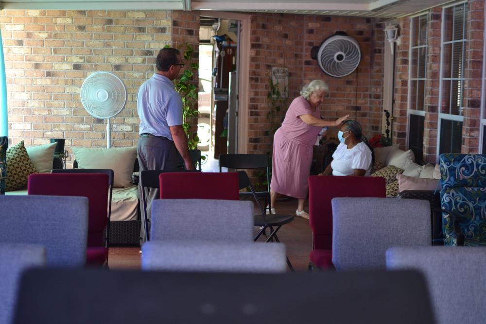 A longtime member of the Iglesia Pentecostal Providencia Divina blesses another church member at the makeshift church in Pastor Rivera's home in early October.