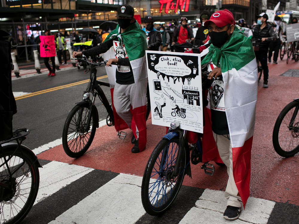 Food delivery riders take part in a street protest ride organized by the group 
