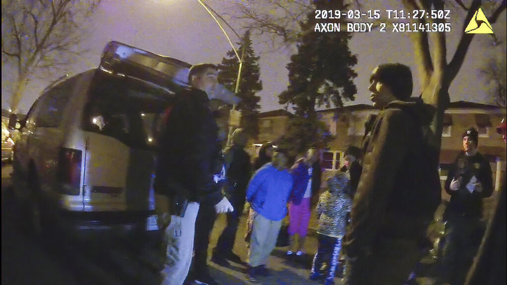 This image provided by the Chicago Police Department shows an image from video from a police worn body camera on March 15, 2019, in Chicago. Royal Smart, 8, in blue was handcuffed by police in south Chicago. Police were looking for illegal weapons and found none. No one was arrested.