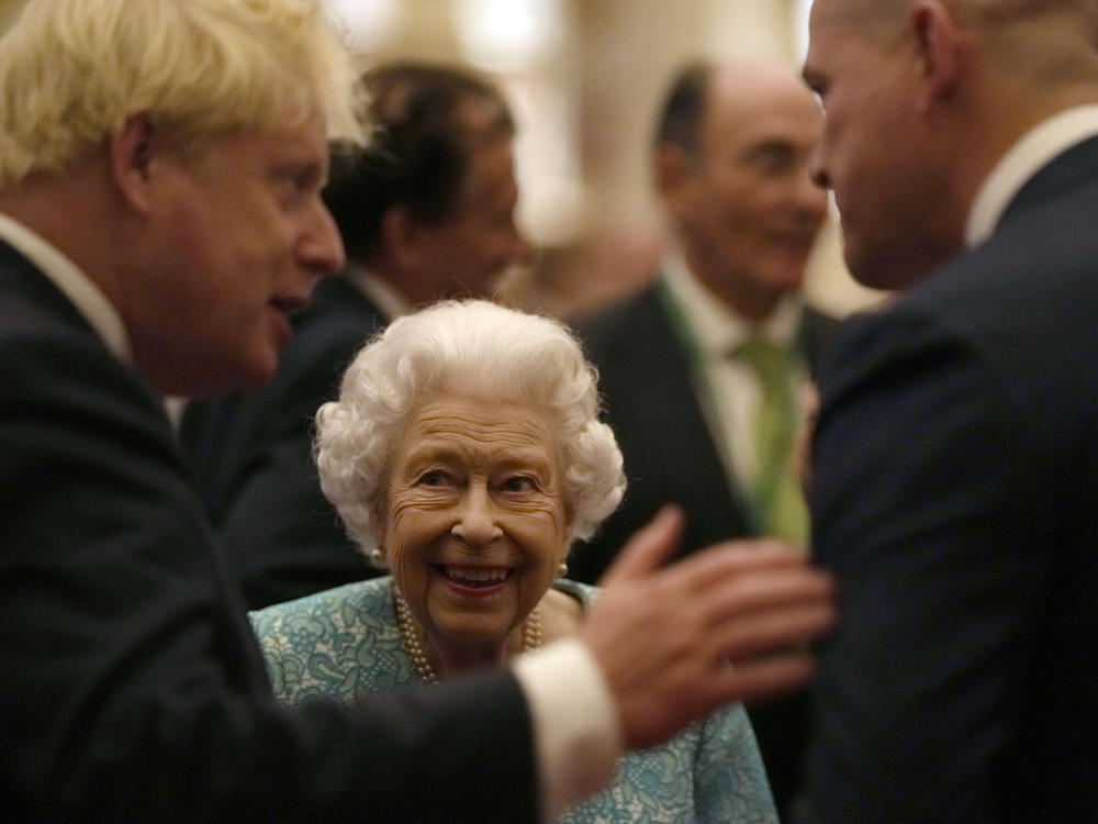 Britain's Queen Elizabeth II and Prime Minister Boris Johnson, left, greet guests at a reception at Windsor Castle, Windsor, England, Oct. 19, 2021.