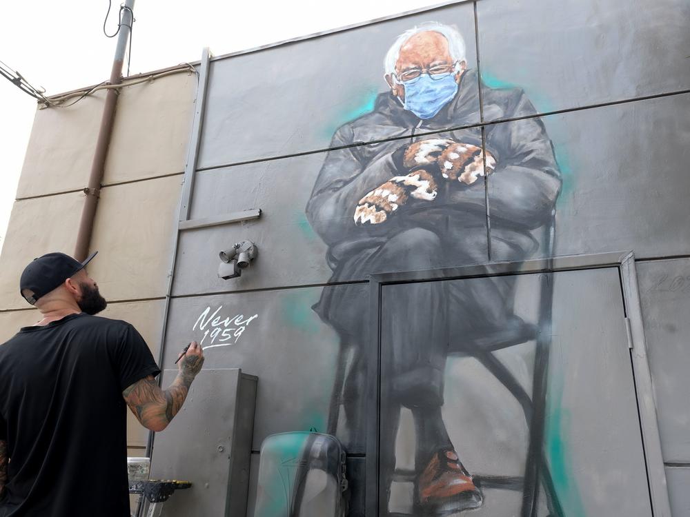 Artist Jonas Never (@never1959) applies finishing touches to his mural of Sen. Bernie Sanders in Culver City, Calif., on Jan. 24. Standing out in a crowd of glamorously dressed guests, Sanders showed up for the presidential inauguration in a heavy winter jacket and patterned mittens — with an AFP photo of the veteran leftist spawning the first viral meme of the Biden era.