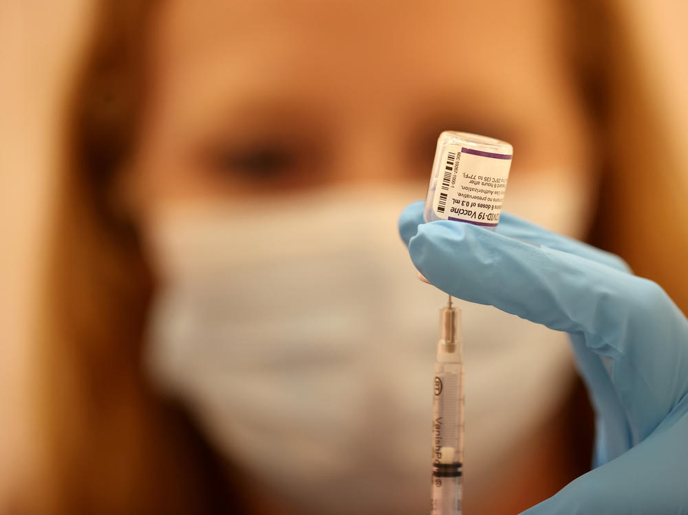 Safeway pharmacist Ashley McGee fills a syringe with the Pfizer COVID-19 booster vaccination at a vaccination booster shot clinic on Oct. 1, in San Rafael, Calif.