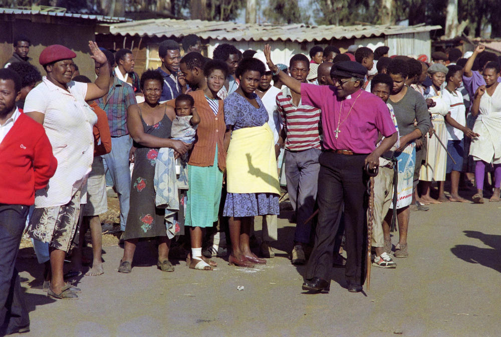 Desmond Tutu greets residents of the Phola Park squatter settlement, east of Johannesburg, in 1990.