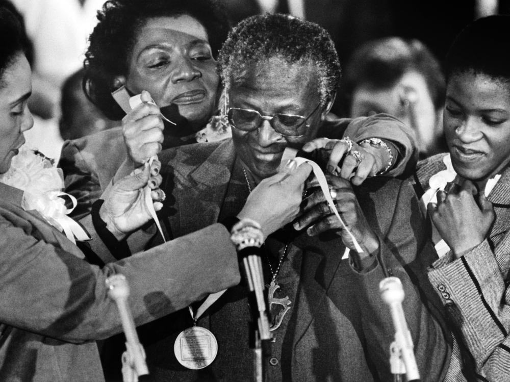 In 1986, South African activist, Nobel Peace Prize recipient and Anglican Archbishop Desmond Tutu receives the Martin Luther King Jr. Nonviolent Peace Prize for his commitment and role during the struggle against apartheid, from Coretta Scott King (left), her daughter Christine King Farris (rear) and Tutu's daughter Nontombi Naomi Tutu.