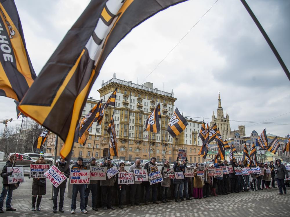 Russian demonstrators hold anti-American posters outside the U.S. Embassy in 2015. From the 1960s through the 1980s, the U.S. said the Soviet Union beamed microwave signals at the U.S. Embassy in an attempt to collect intelligence.