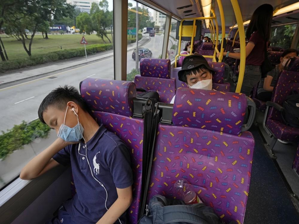 Passengers sleep on the upper deck of a double-decker bus in Hong Kong on Saturday.