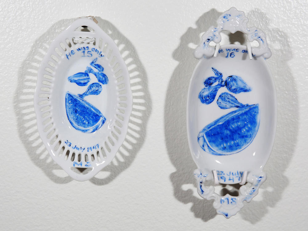 Plates depicting what two juveniles on Death Row ate for their final meals, painted by artist Julie Green.