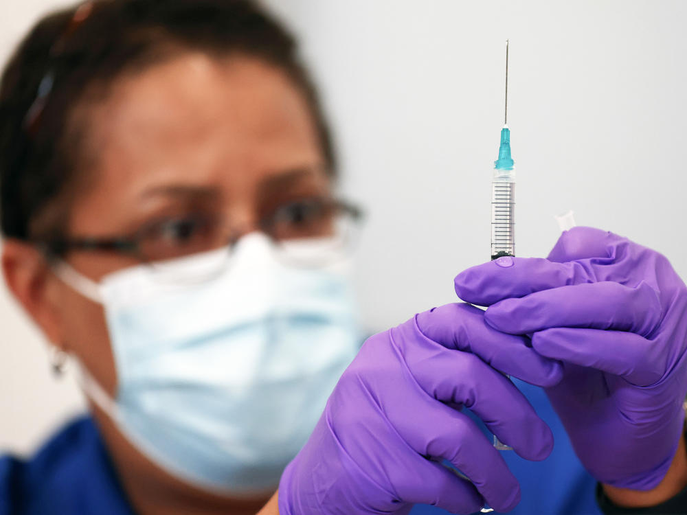 Pharmacist LaChandra McGowan prepares a dose of the Pfizer COVID-19 vaccine at a clinic operated by DePaul Community Health in New Orleans in August. Soon, children ages 5 to 11 could be eligible for Pfizer shots.