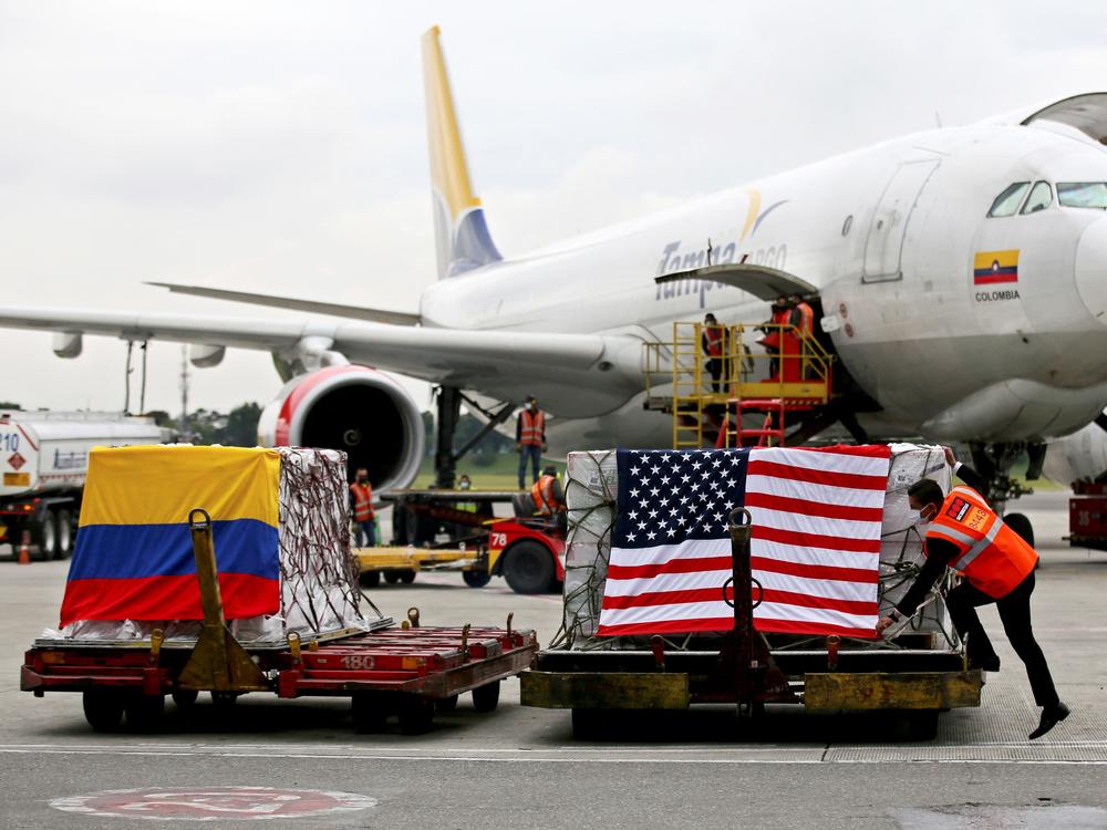 Containers of Moderna COVID-19 vaccine doses, donated by the United States, arrive in Bogota, Colombia, in July. The U.S. plans to send more than a billion vaccines abroad by September 2022.
