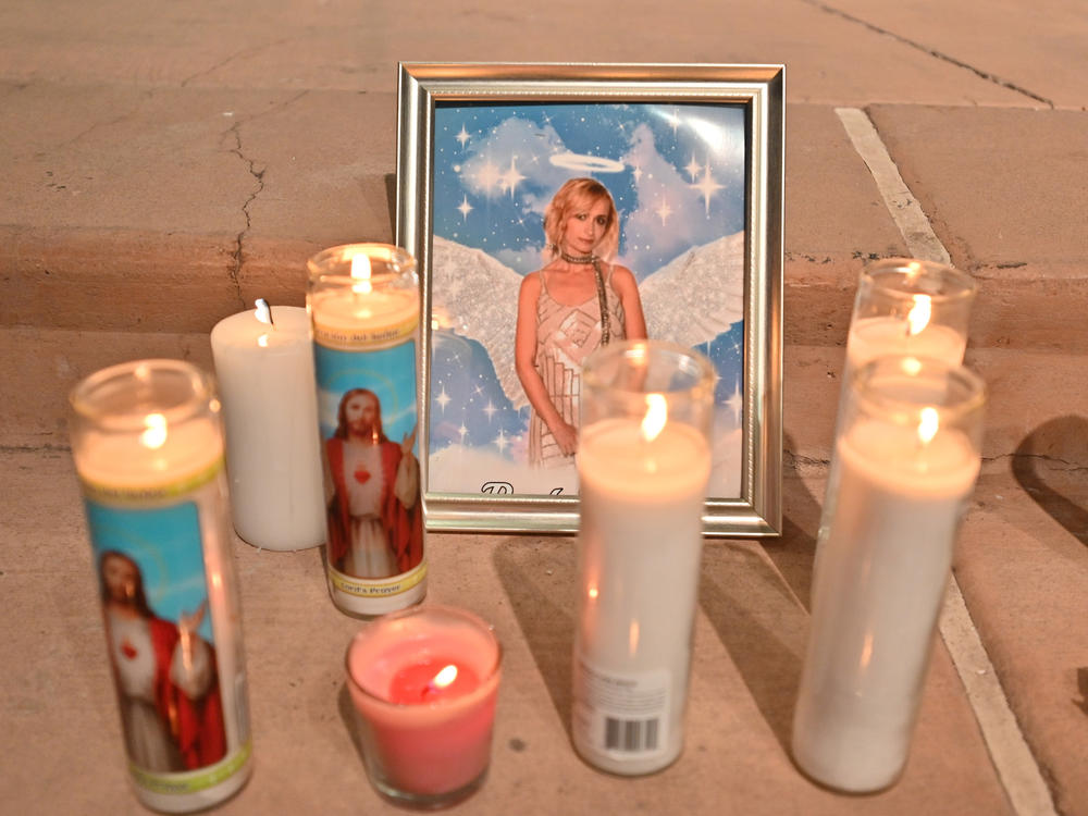 Candles surround a photo of cinematographer Halyna Hutchins during a vigil on Oct. 23 in Albuquerque, New Mexico. The American Film Institute established a scholarship in honor of Hutchins, who was killed by a prop gun on the set of the movie 