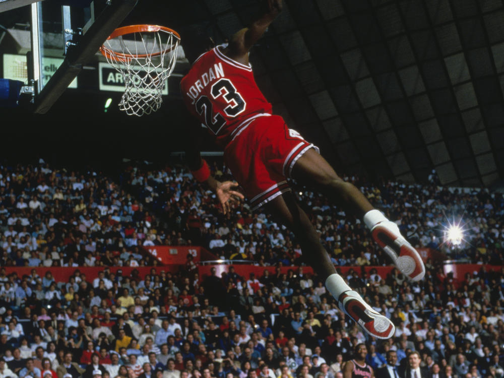 UNDATED: Chicago Bulls' forward Michael Jordan #23 dunks as the crowd takes photos during a game against the Portland Trail Blazers circa 1984-1998. (Photo by Focus on Sport via Getty Images)
