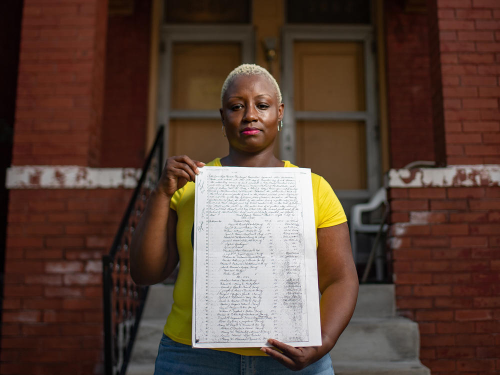 Shemia Reese holds the racial covenant that was in place for her home in St. Louis, Mo.