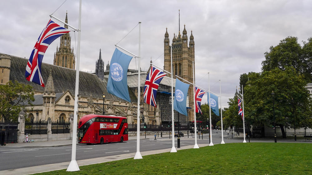 British and U.N. flags fly in London on Sunday, ahead of the upcoming U.N. climate conference in Glasgow, Scotland.