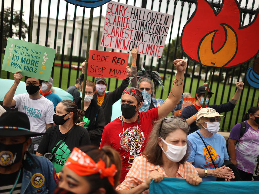 Demonstrators prepare to be arrested during a climate rally outside the White House on October 13.