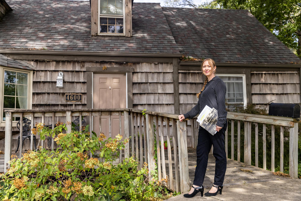Council member Inga Selders stands at her childhood home, where she lives in Prairie Village, Kan. Selders stumbled upon a racially restrictive housing covenant in her homeowners association property records. She's working to remove it<strong> </strong>but has faced pushback from other council members, as they think amendments to these covenants suffice and removing them would be removing history.