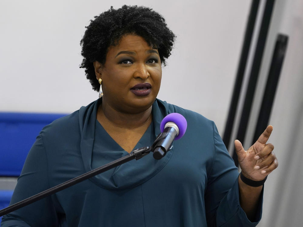 Stacey Abrams speaks during a church service in Norfolk, Va., on Oct. 17. A political organization led by the Democrat is branching out into paying off medical debts. Fair Fight Action said it's donating $1.34 million from its political action committee to wipe out debt owed by 108,000 people in Georgia, Arizona, Louisiana, Mississippi and Alabama.