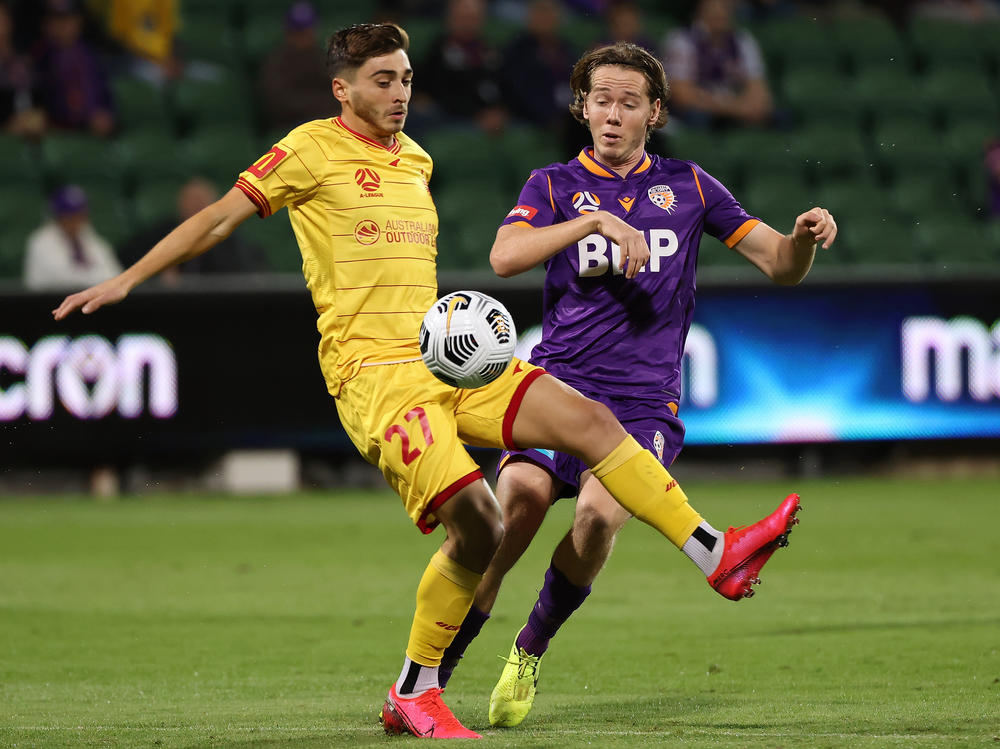 Josh Cavallo of Adelaide, left, and Daniel Stynes of the Glory contest for the ball during the A-League match between Perth Glory and Adelaide United at HBF Park, on May 19 in Perth, Australia.