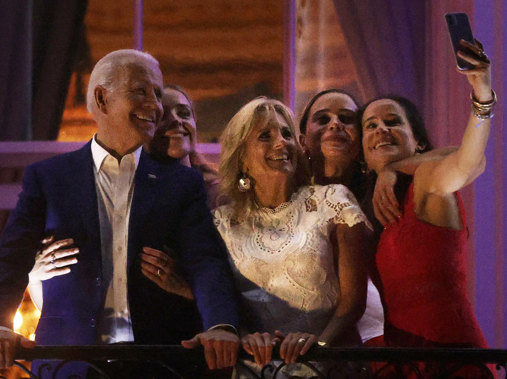 President Biden and first lady Jill Biden, along with other Biden family members, pose for a selfie as they watch a fireworks display during a barbecue event at the White House on July 4. Hopes about the economy on Independence Day were dashed by the spread of the delta variant and supply chain woes.