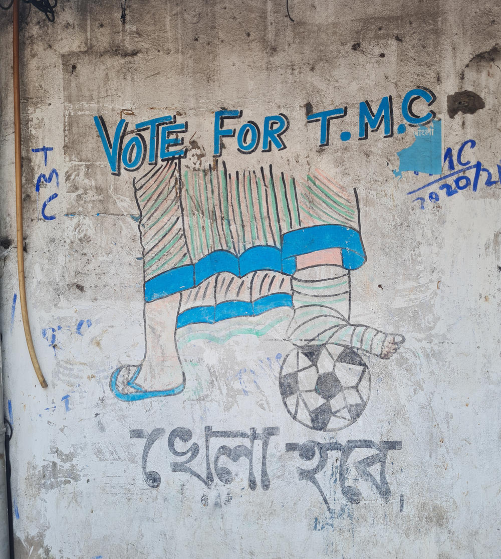 Graffiti in central Kolkata depicts Mamata Banerjee playing soccer with a cast on her leg. 