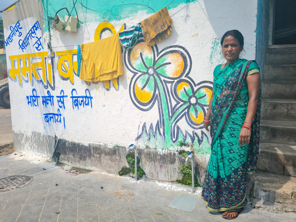 Reeta Thakur, 40, a housewife in Kolkata, poses in front of graffiti congratulating Mamata Banerjee, the chief minister of West Bengal, on her win in a recent by-election.