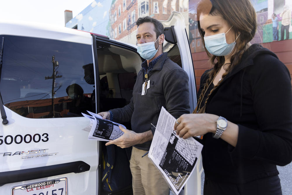 City public health department nurses Kevin Lagor and Louise Bisby, part of new mobile outreach teams, get supplies out of their SUV to bring to people who have recently survived a drug overdose.