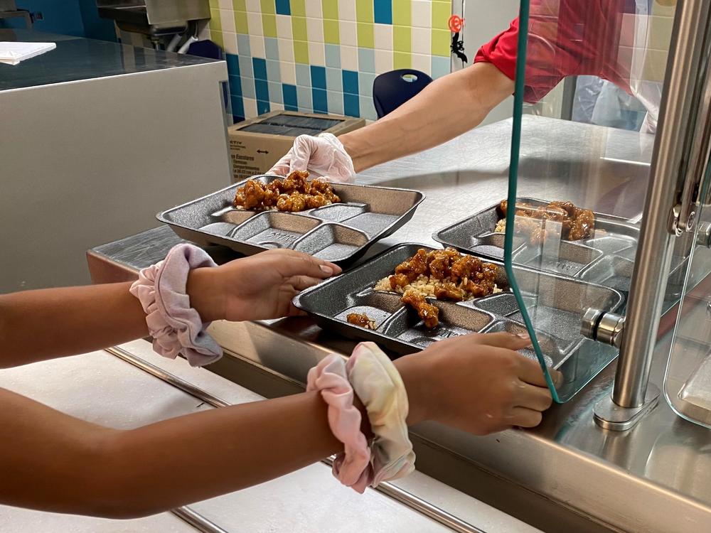 For many public school districts, meals like this Mandarin chicken at Compass Elementary in Kansas City are the culmination of a kind of treasure hunt to source food.