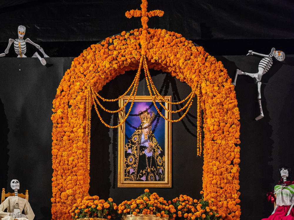 This Día de los Muertos altar on display at a public shrine in Oaxaca, Mexico, shows several traditional <em>ofrendas</em>, including <em>cempasúchil --</em> the Aztec name of the marigold flower native to Mexico.