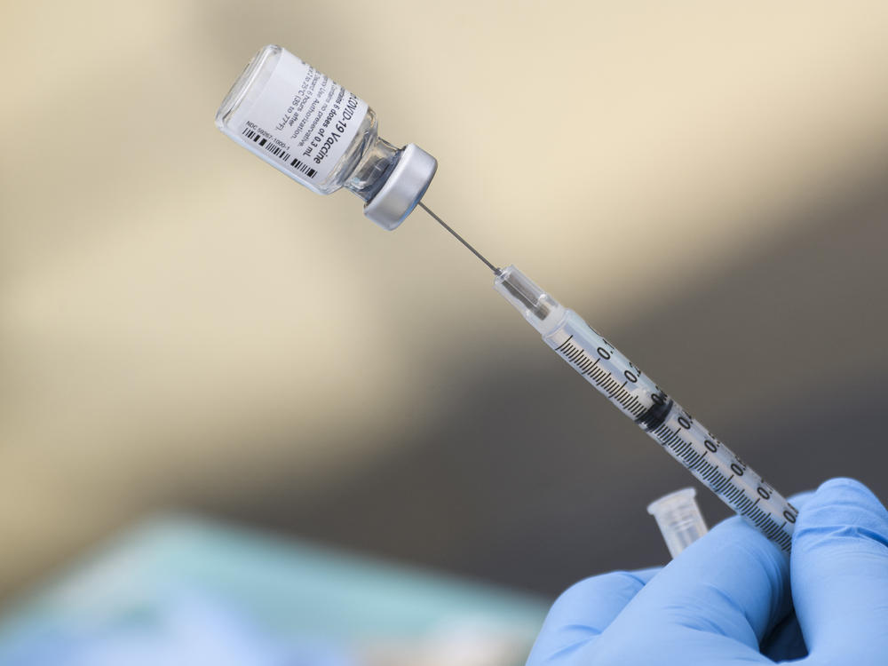 A syringe is filled with a dose of the Pfizer-BioNTech COVID-19 vaccine. While the vaccine has now been authorized for children between ages 5 and 11, it may take several weeks for shots to become widely available.