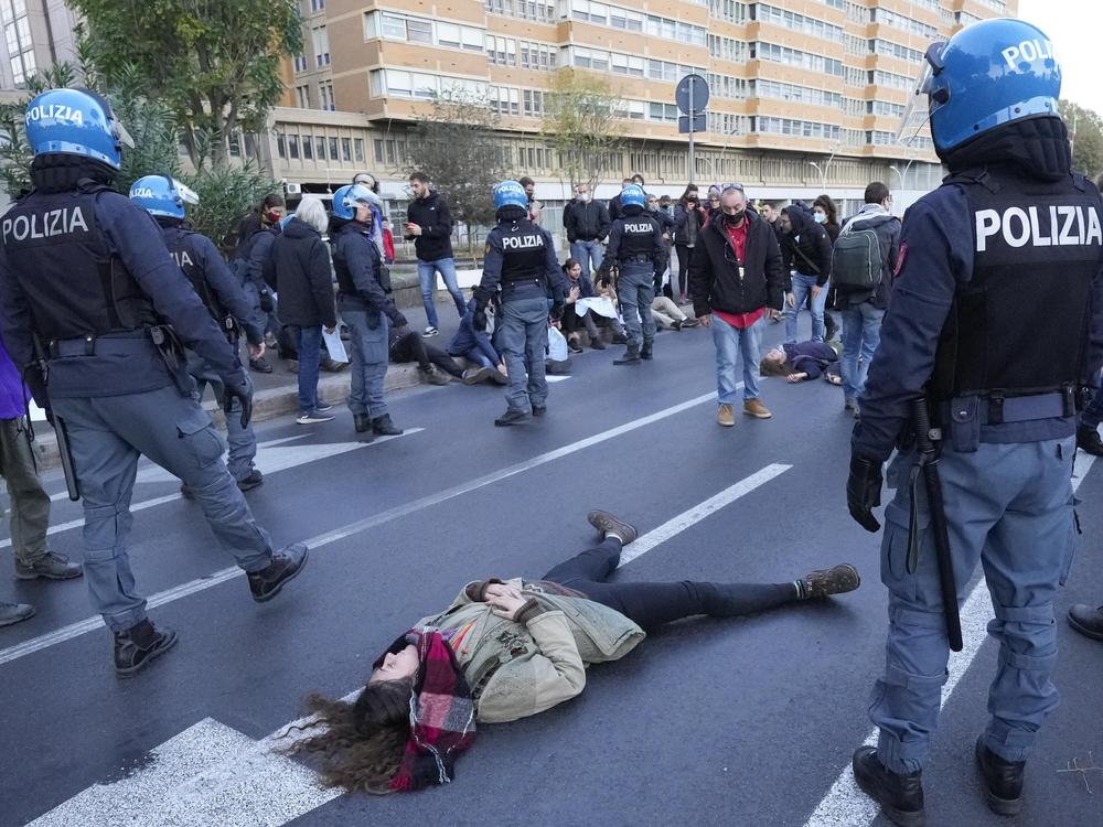 Climate activists try to block traffic on a main road leading to La Nuvola, the Rome convention center where the G-20 summit is taking place.
