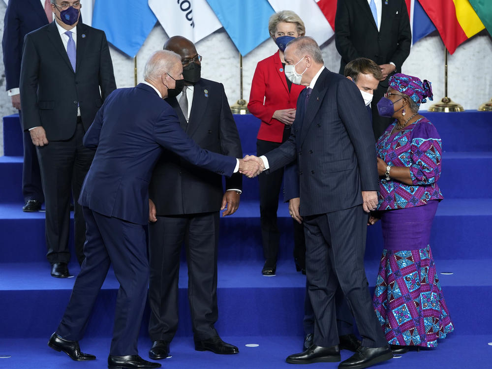 President Biden greets Turkey's President Recep Tayyip Erdogan during a group photo at the G-20 summit.