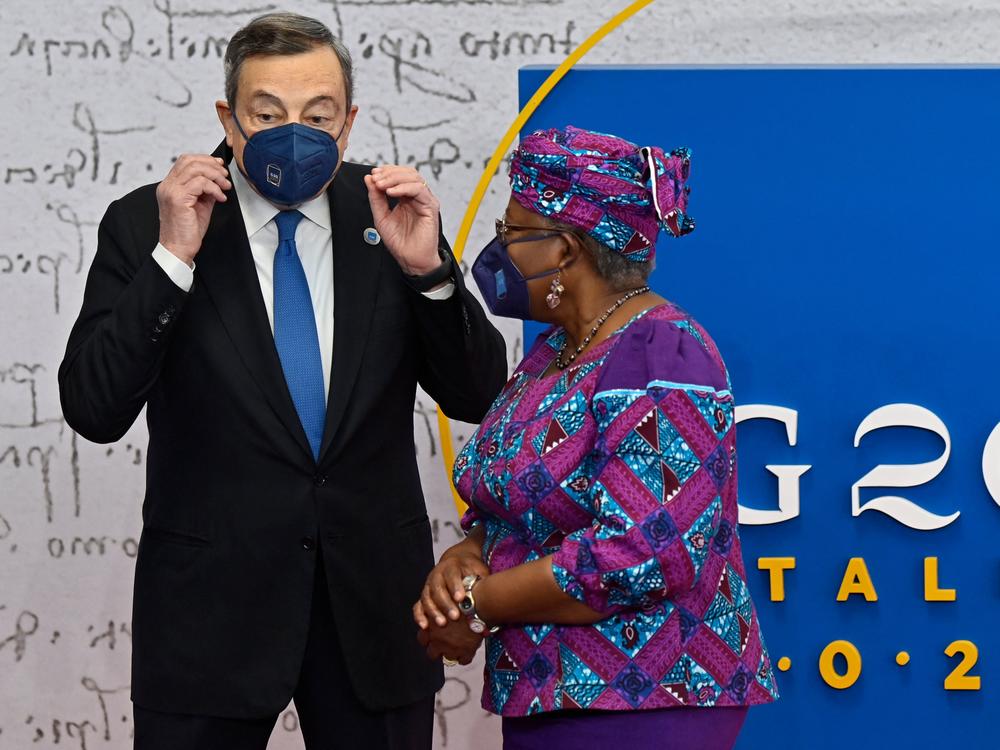 Italian Prime Minister Mario Draghi greets World Trade Organization Director-General Ngozi Okonjo-Iweala as she arrives for the G-20 summit.