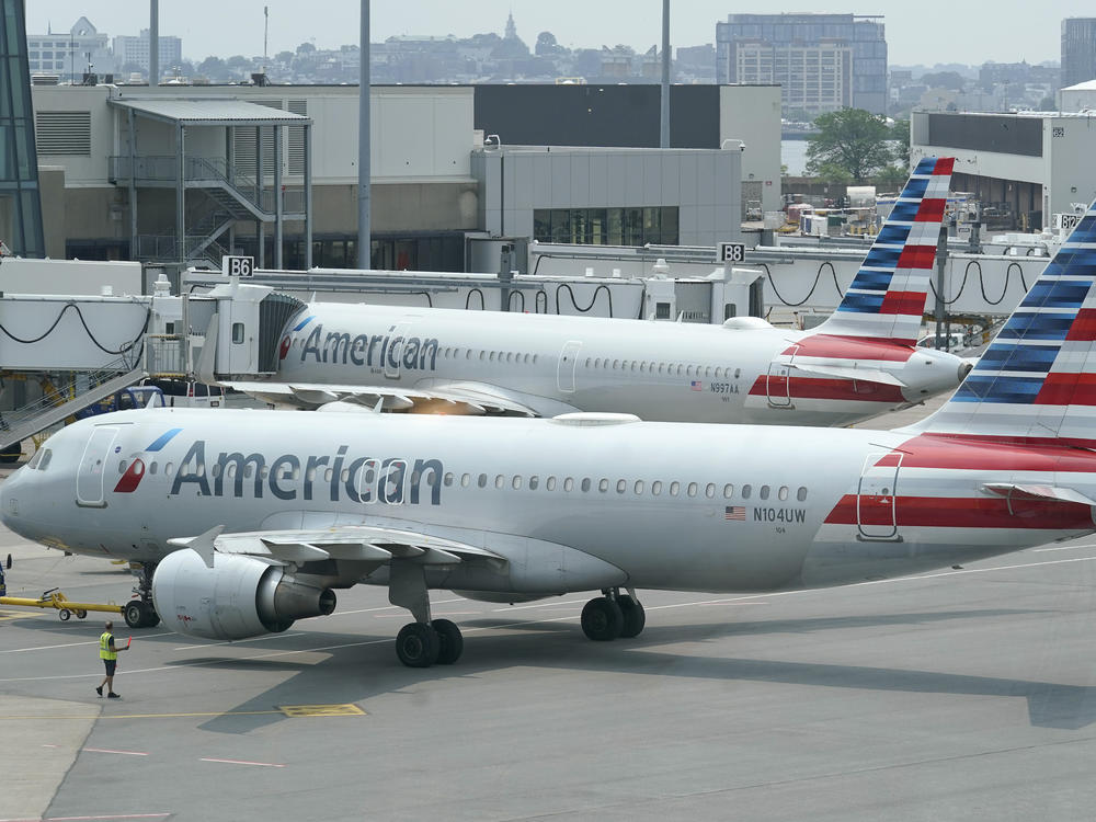 American Airlines passenger jets prepare for departure near a terminal at Boston Logan International Airport, in Boston in July. More than 1,000 flights were canceled this weekend due to weather and staffing shortages, the airline said.