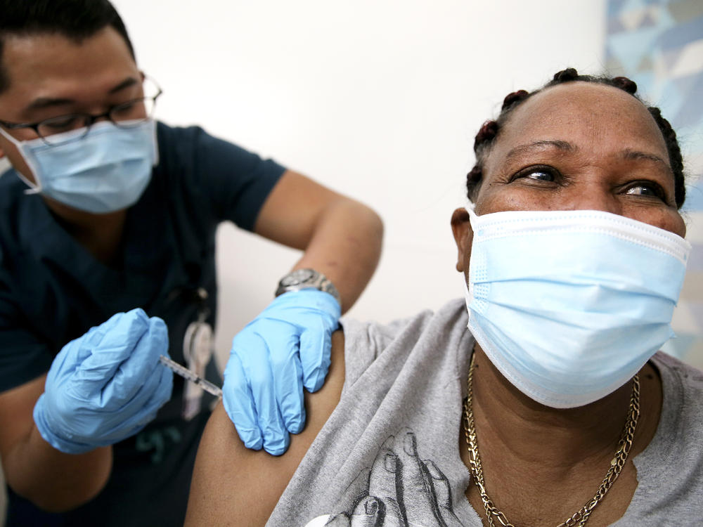 An in-home care worker receives her first dose of the COVID-19 vaccine in February in Los Angeles, Calif.