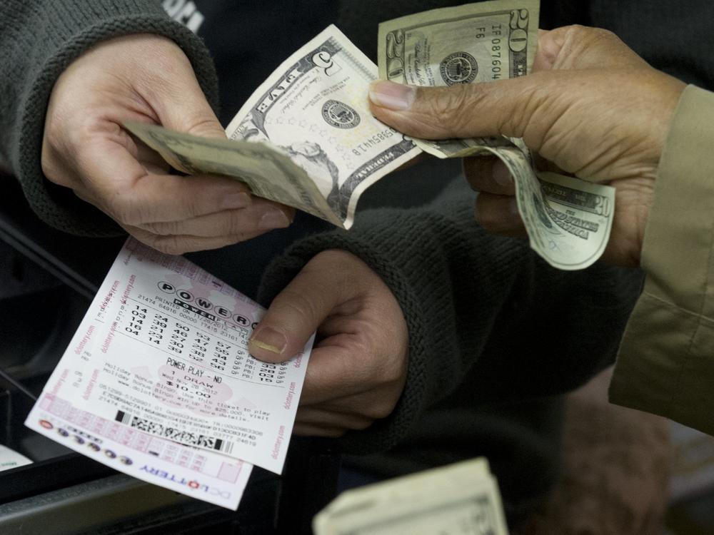 A customer purchases Powerball lottery tickets in Washington in 2012. The Maryland Lottery says a retired utility worker has won a $2 million prize for the second time since 2018.