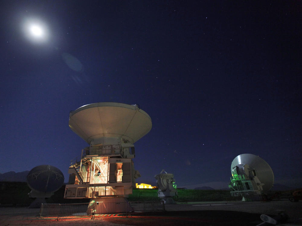 The moon shines over radio antennas at the operations support facility of one of the worlds largest astronomy projects, the Atacama Large Millimeter/submillimeter Array (ALMA), in the Atacama desert in northern Chile in this 2012 photo.