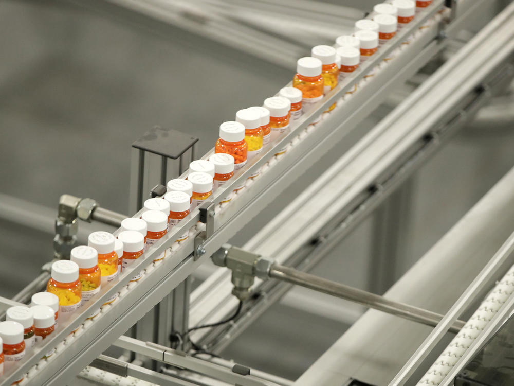 Bottles of medicine ride on a belt at the Express Scripts mail-in pharmacy warehouse in Florence, N.J., in 2018. Democratic lawmakers have reached a deal to lower prescription drug prices for seniors.