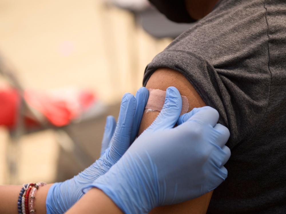 A person receives a bandage after their first dose of the Pfizer COVID-19 vaccine at a mobile vaccination clinic during a back to school event in August. Vaccines could be available for kids ages 5 to 11 as early as next week.