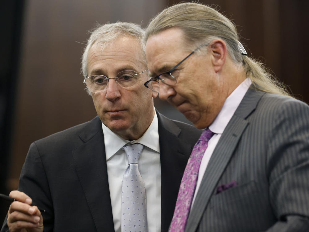 Defense attorneys Franklin Hogue (R) and Robert Rubin talk during jury selection in the trial of the men charged with killing Ahmaud Arbery. Greg and Travis McMichael and their neighbor, William 