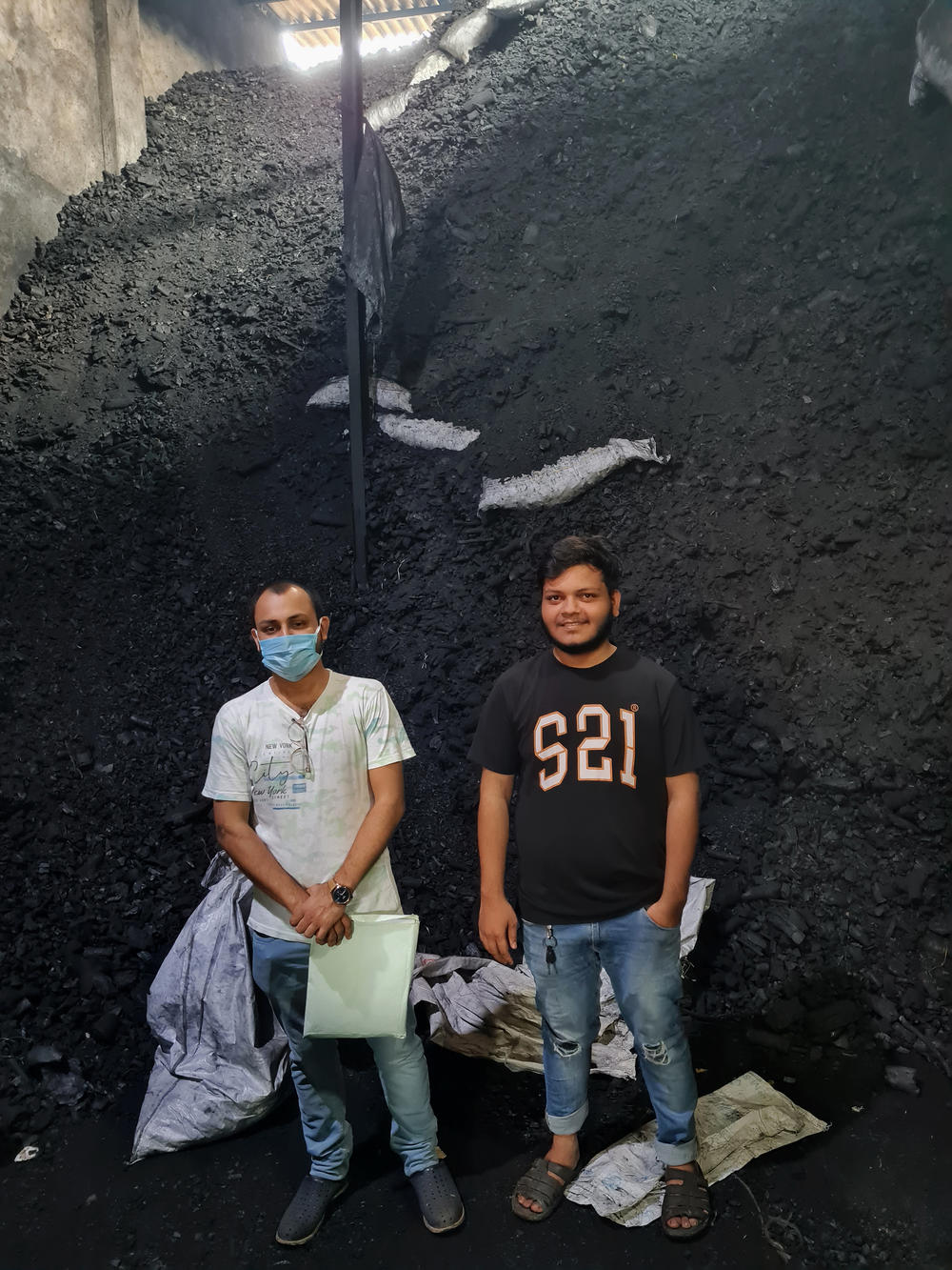 Abdul Moeed Chaudhary (left), 30, and his nephew Abdul Rakib Chaudhary (right), 21, are the third and fourth generations of their family to run the Choudhury Coal Depot in Mumbai. Abdul Moeed Chaudhary recently earned a master's degree in renewable energies, and wants to diversify the family business.