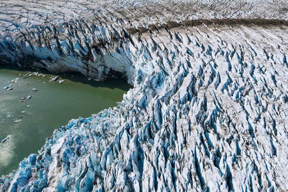 Greenland's melting ice is raising sea levels in coastal cities around the world. Limiting warming to 1.5 degrees Celsius could halve the amount oceans rise, compared with where they're headed now.