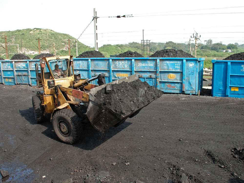 A bulldozer loads coal onto railway wagons at the Jharia coalfield in Dhanbad in India's Jharkhand state.