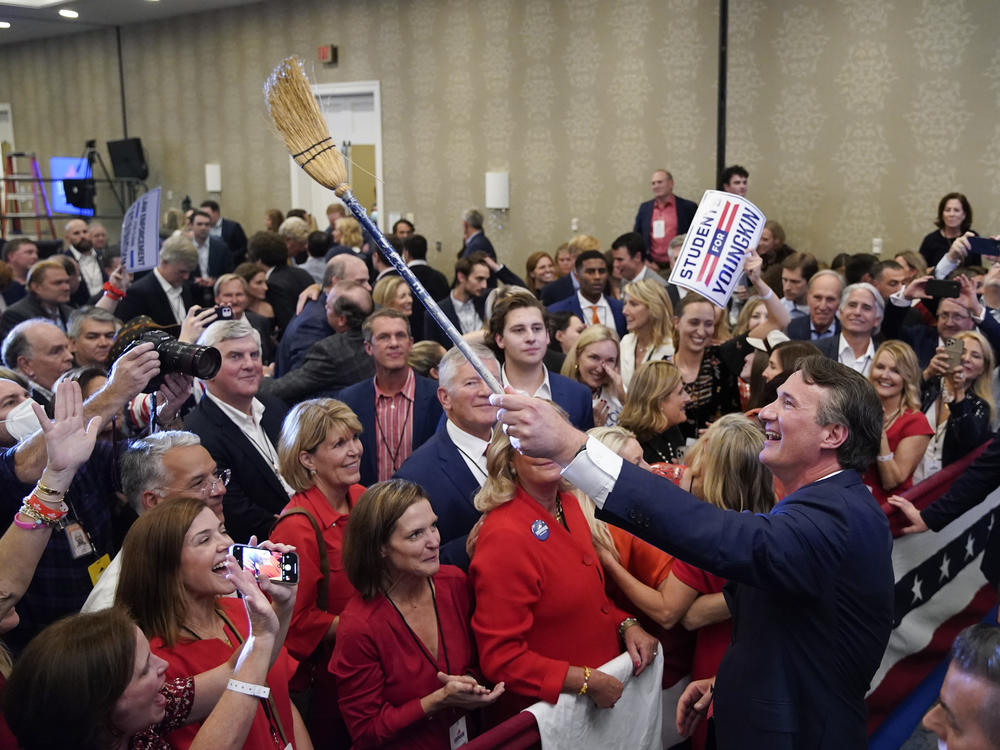 Glenn Youngkin, governor-elect of Virginia, holds a broom while greeting attendees after speaking during an election night event in Chantilly, Va. Youngkin defeated Democrat Terry McAuliffe in Virginia's closely watched governor's race.