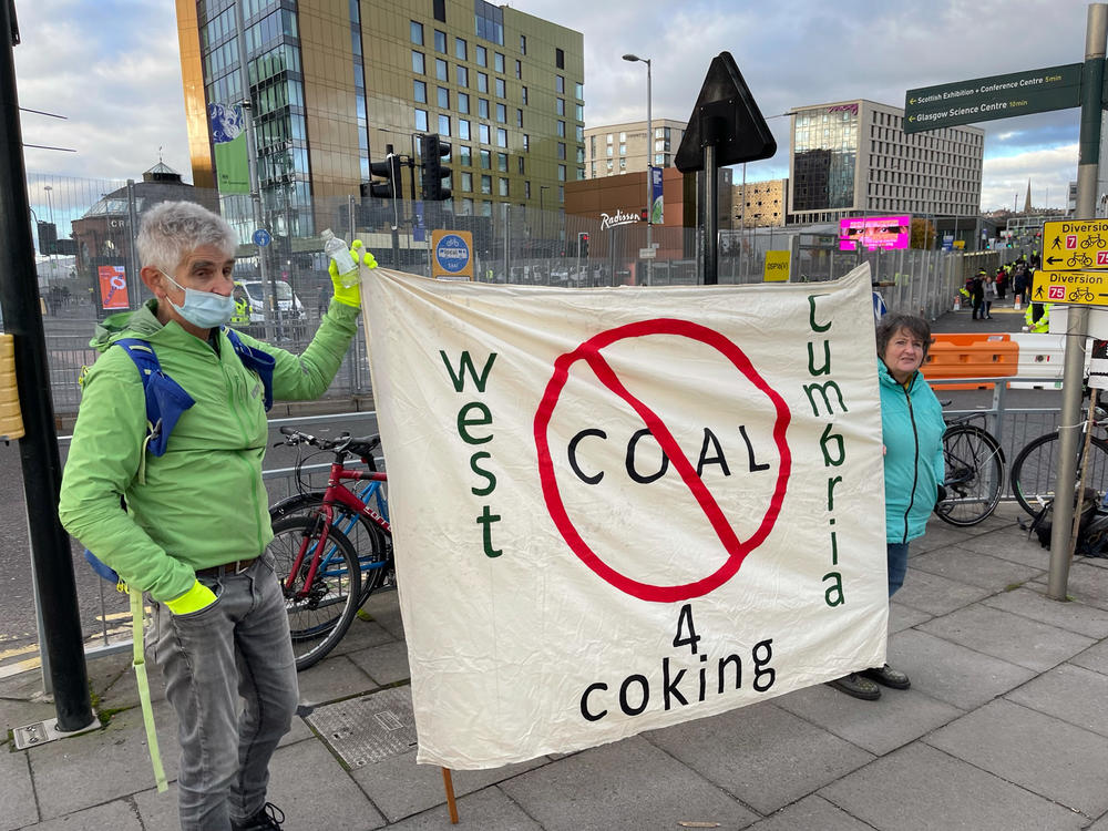Activists hold a banner against West Cumbria's planned coking coal mine as they stand near the Scottish Event Campus, the venue for the U.N. climate summit, in Glasgow.