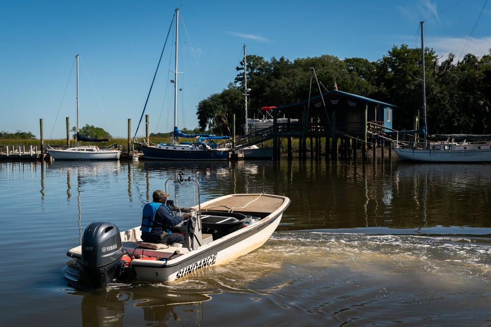 Ed Atkins, a Gullah fisherman and bait shop owner, launches his boat from Sams Point on Lady Island, S.C.