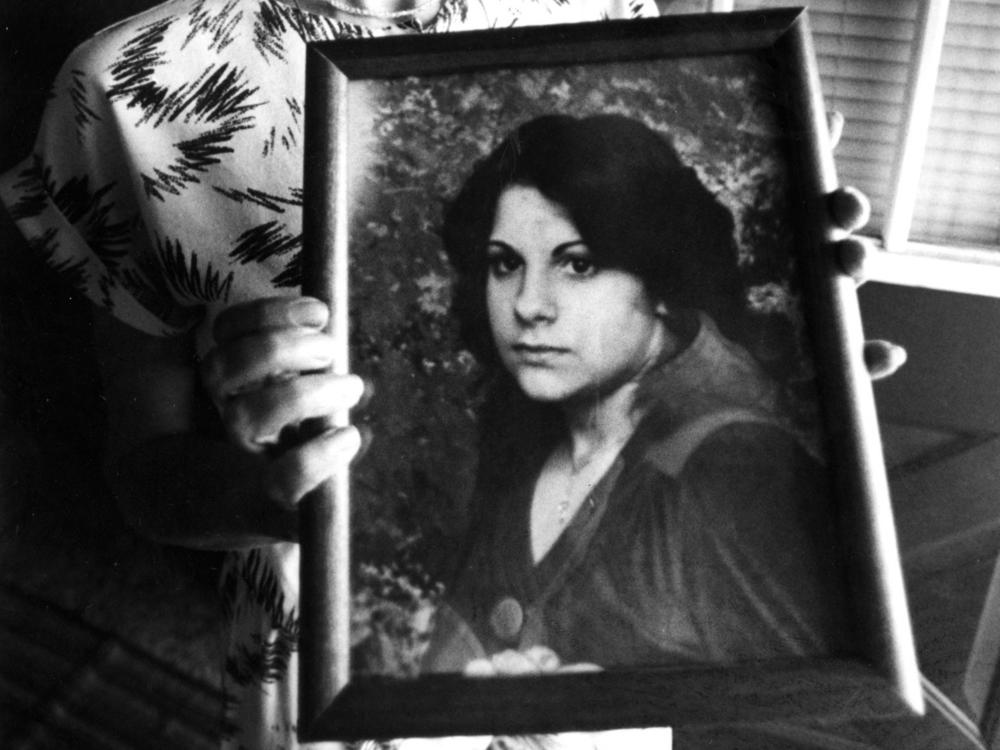 Judy Chartier holds a photograph of her missing daughter, also named Judith 