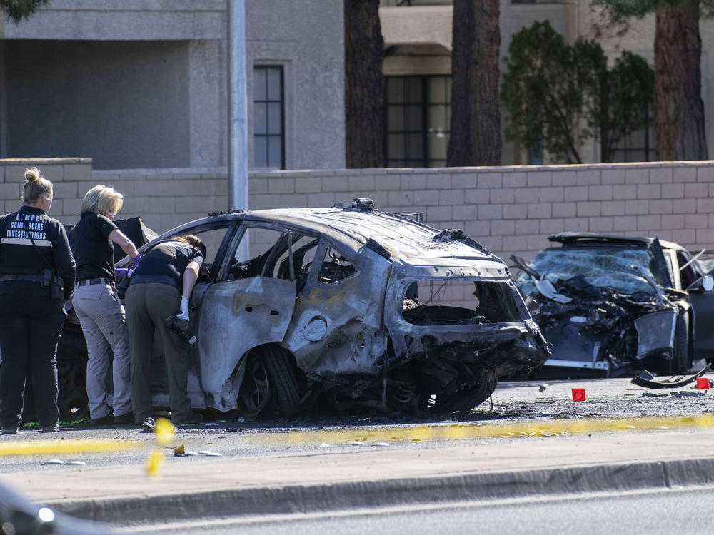 Las Vegas Metro Police investigators work at the scene of a fatal crash Tuesday. Police say Las Vegas Raiders wide receiver Henry Ruggs III was involved in a fiery crash that left a woman dead and Ruggs and his female passenger injured.