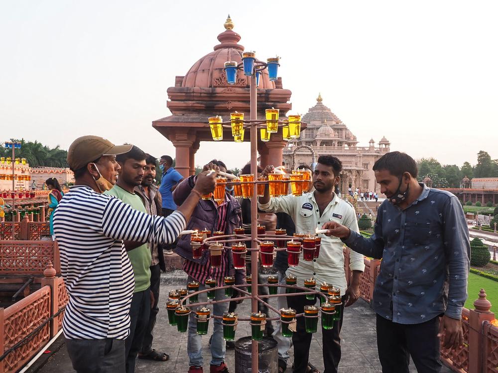 People light oil lamps on the eve of Diwali at the Akshardham Hindu temple in Gandhinagar, India, on Wednesday.