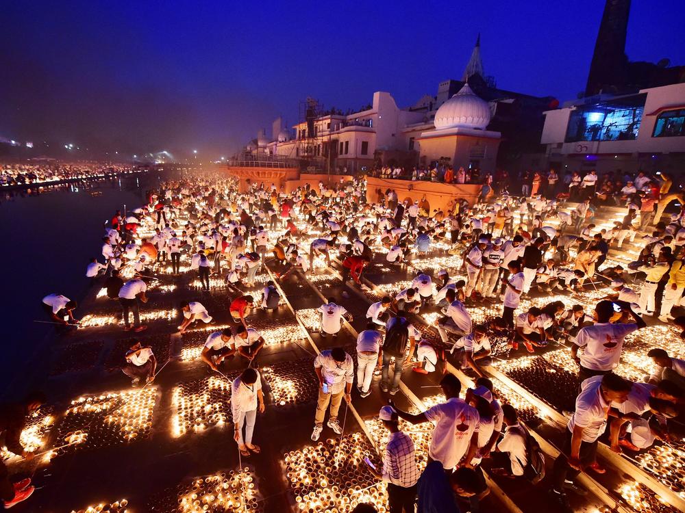 People light earthen lamps on the banks of the river Sarayu during Deepotsav celebrations on the eve of the Hindu festival of Diwali in Ayodhya.