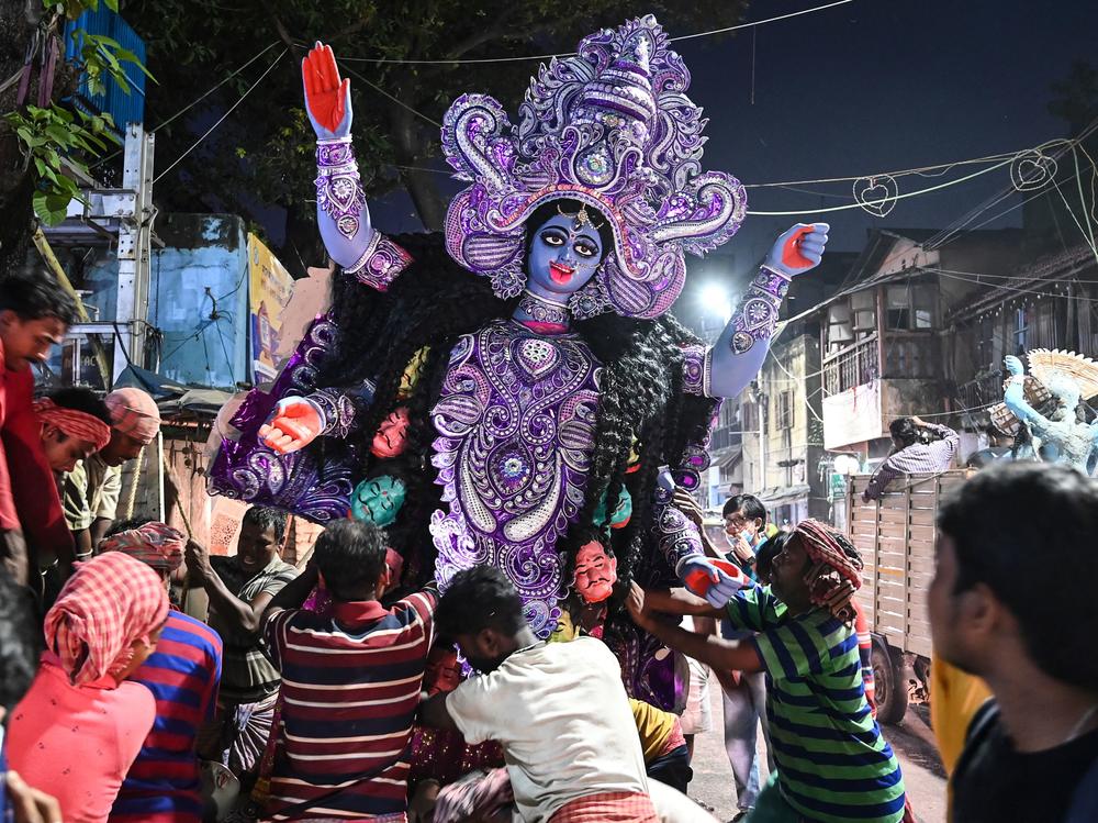 Laborers transport an idol of the Hindu goddess Kali to a place of worship on the eve of Diwali at Kumortuli, the traditional potters' quarter in northern Kolkata, on Wednesday.