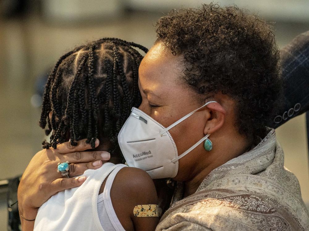 Natasha Greaves holds her daughter, Laila Greaves, 5, after Laila received a Pfizer-BioNtech COVID-19 vaccine on Wednesday in Shoreline, Wash.